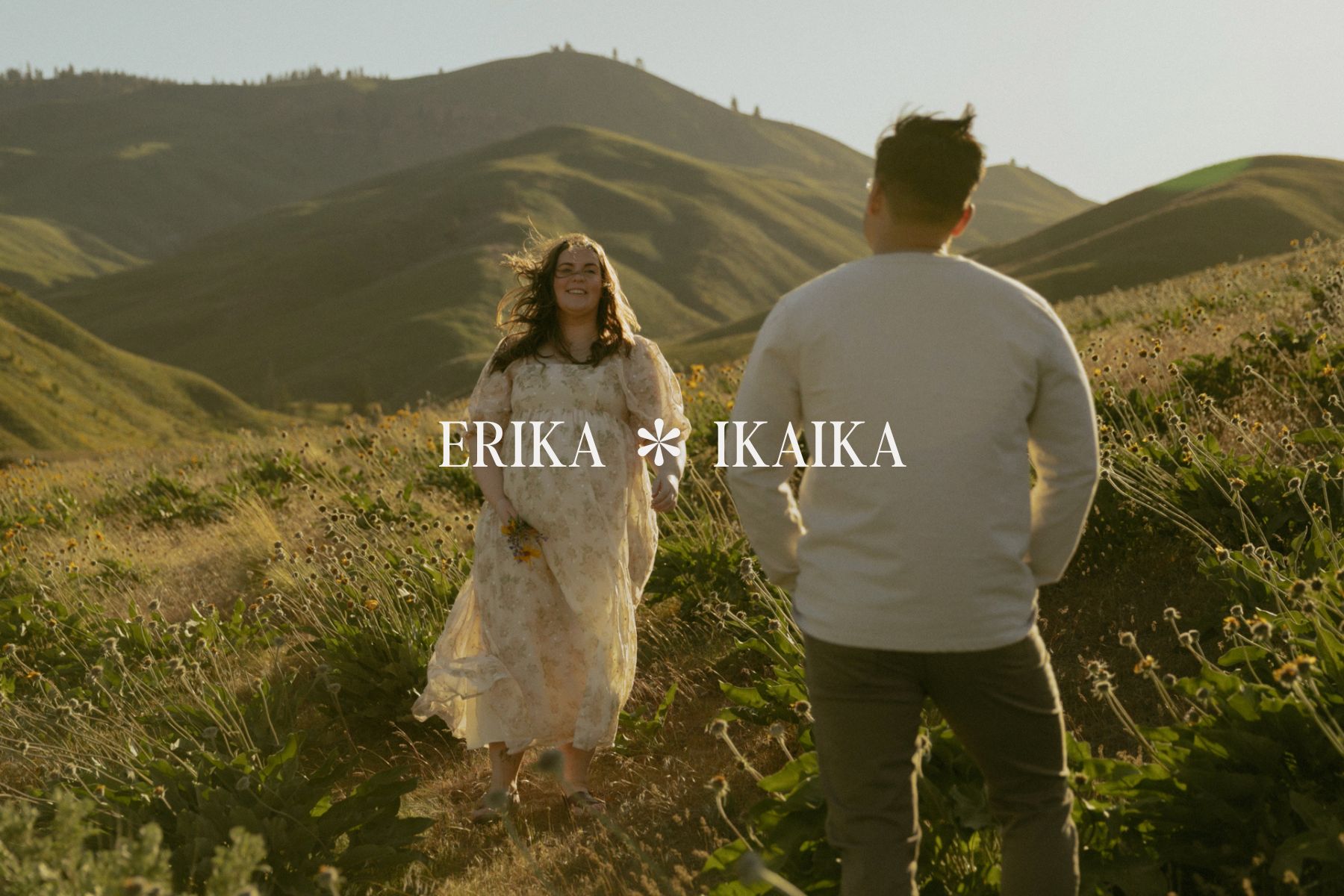 Pregnant woman walking towards her partner in a field of wildflowers