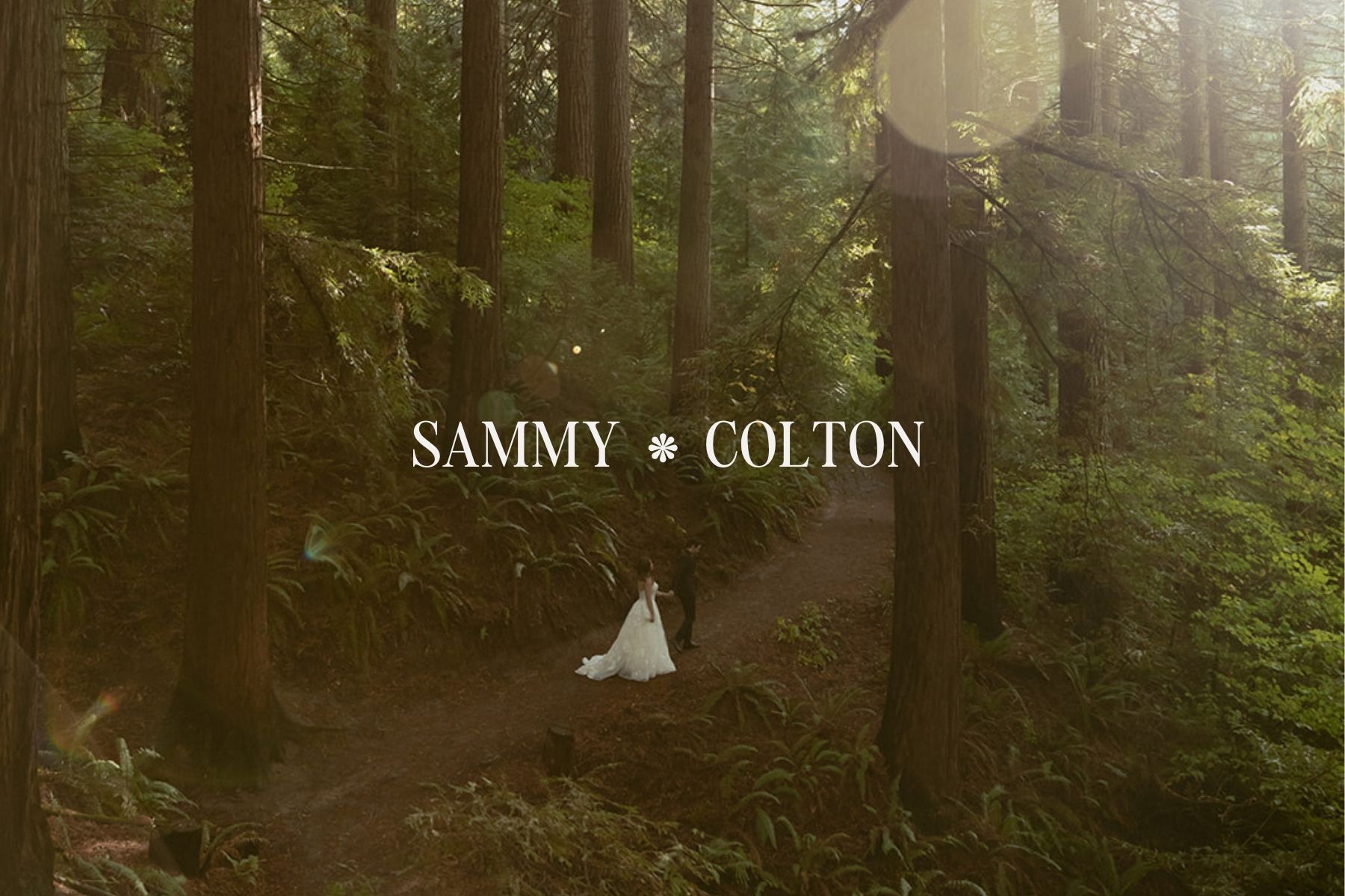 Bride and groom walking together on a forest path surrounded by tall redwood trees during their Portland wedding portraits.